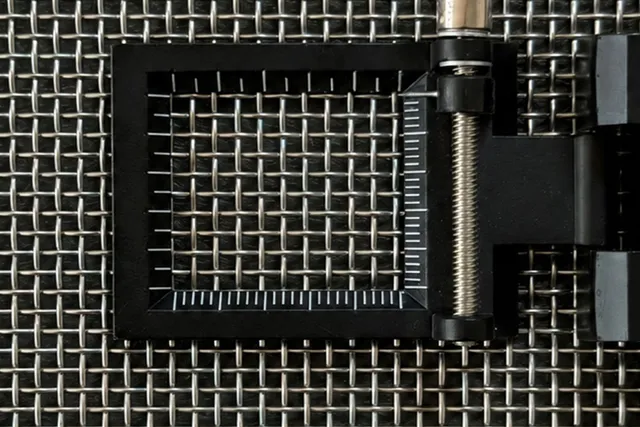 Measurement loupe over woven stainless steel wire mesh for checking mesh count