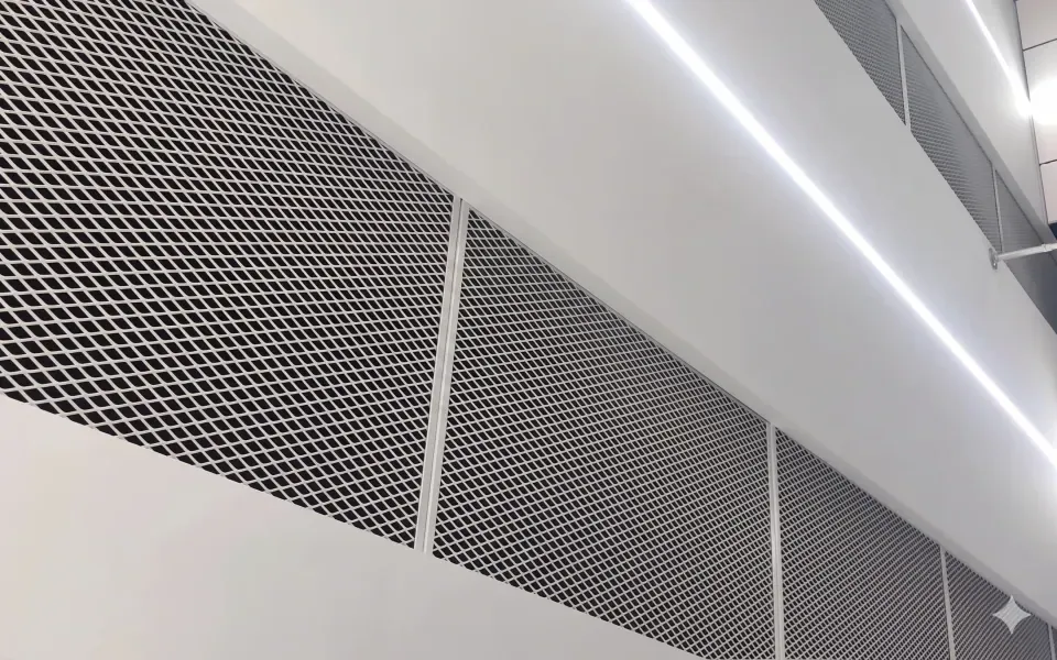White architectural expanded metal screen panels in an interior corridor