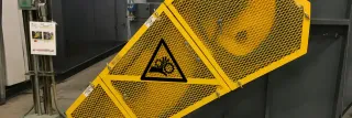 Yellow expanded metal guard panel on industrial equipment