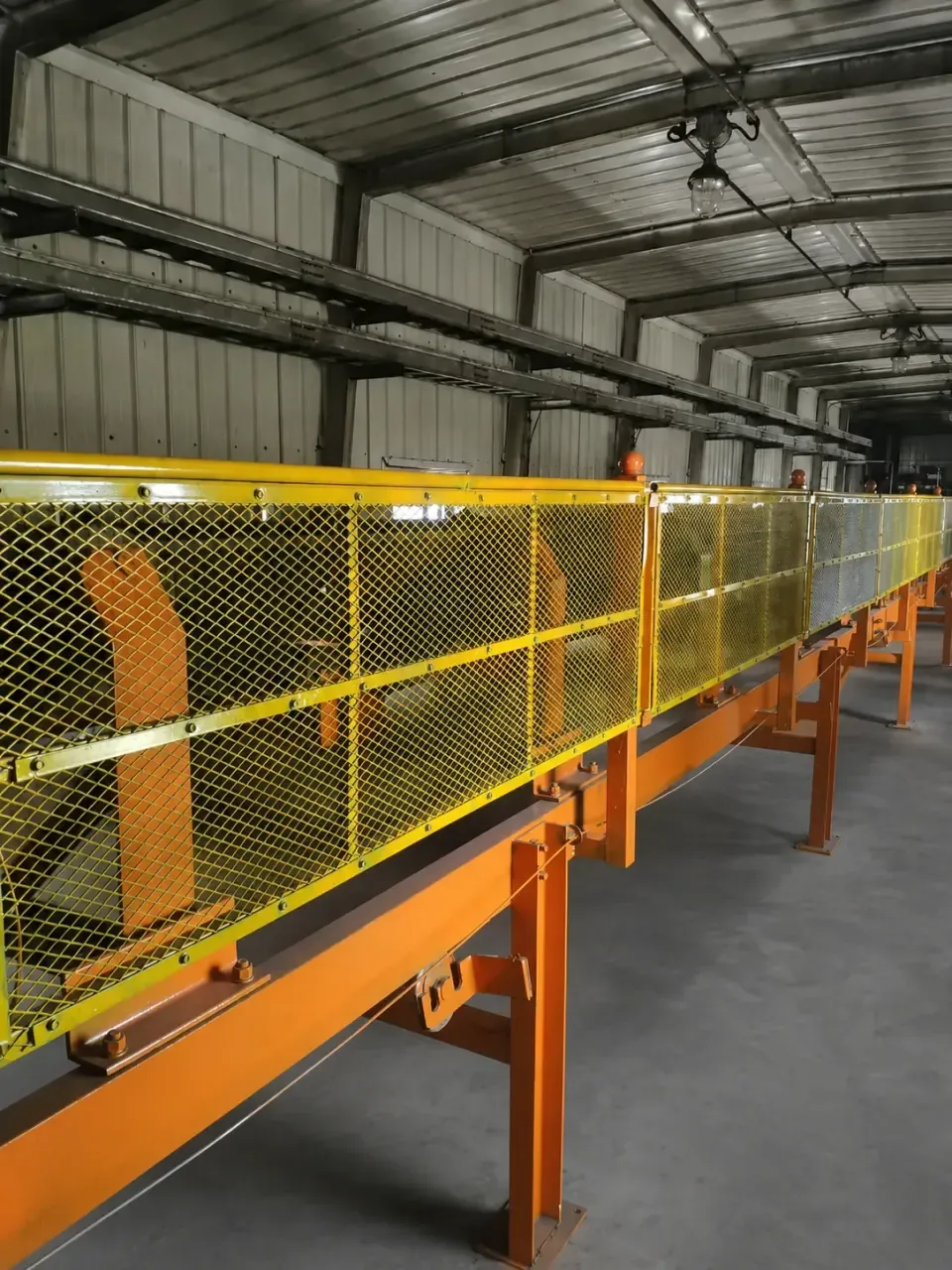Expanded metal conveyor guard panels in a factory