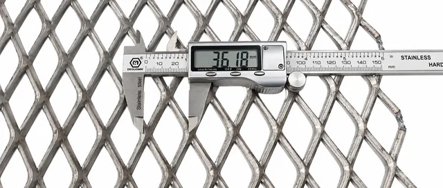 Digital caliper measuring a raised carbon steel expanded metal diamond opening