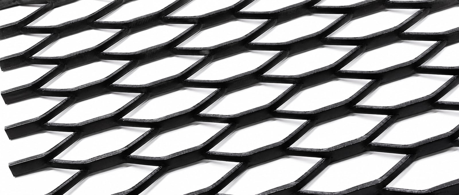 Black raised expanded metal grating close-up with wide diamond openings