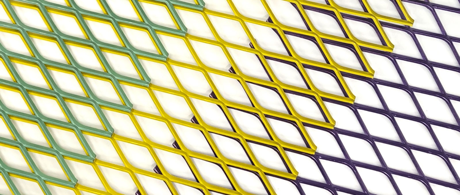 Overlapping green, yellow and purple powder coated expanded metal sheets with diamond openings