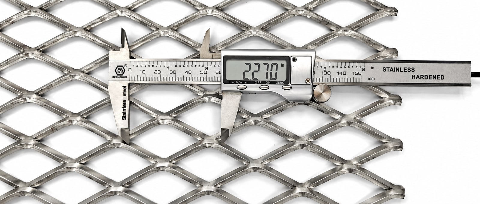 Digital caliper measuring a stainless steel expanded metal diamond opening