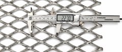 Digital caliper measuring a stainless steel expanded metal diamond opening