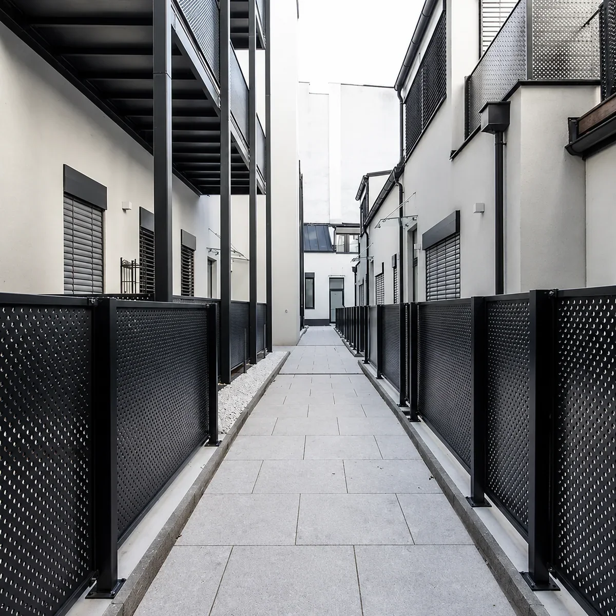 Black perforated metal facade panels used for residential privacy screening