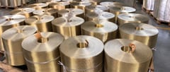 Multiple reverse Dutch weave wire mesh rolls secured with straps and arranged on wooden pallets