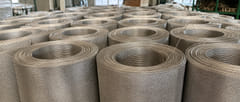 Bulk rolls of 304 stainless steel woven wire mesh stored in the factory