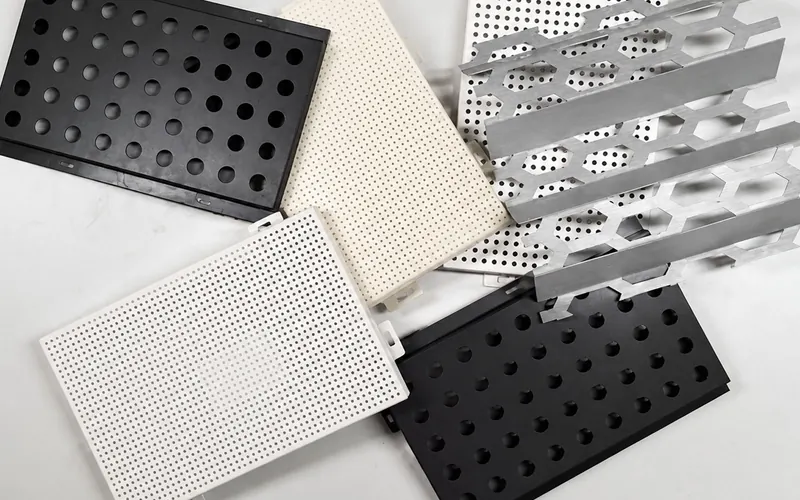 Perforated metal samples with round and hexagonal holes in different finishes